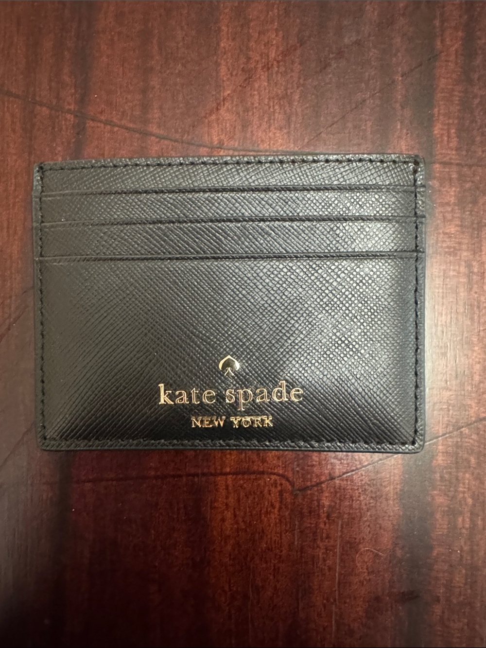 kate spade black card case with gold logo